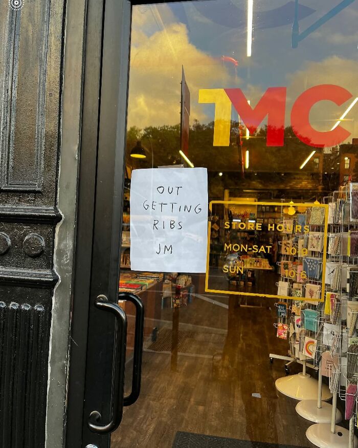 Storefront with a funny sign in New York saying "Out getting ribs."