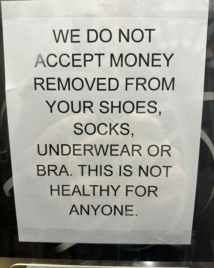 Sign in New York humorously requests not to accept money from shoes, socks, or underwear.