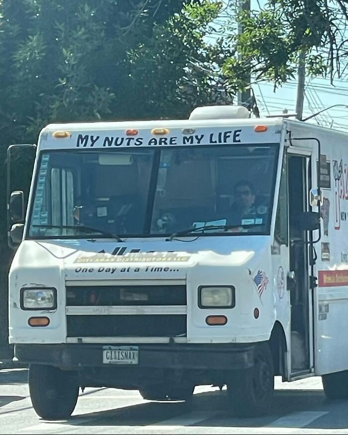 Funny New York truck with "My Nuts Are My Life" sign on the windshield.