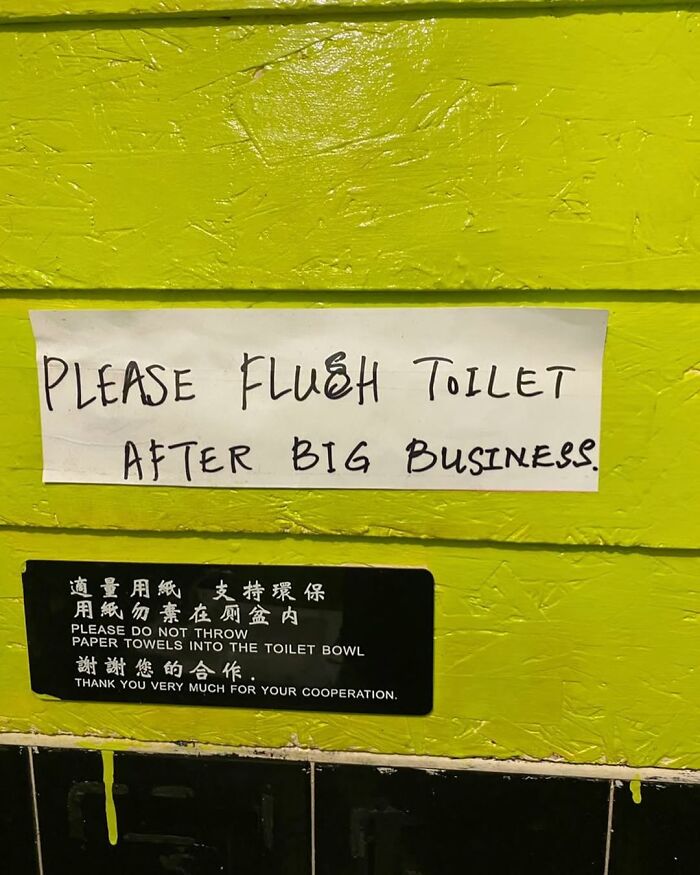 Humorous toilet sign in New York urging to flush after use, on a bright green wall.