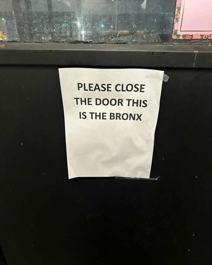 Sign in New York saying "Please close the door, this is the Bronx" on a dark background.