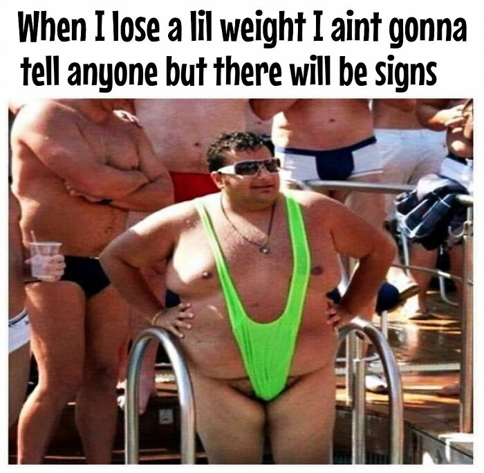 Man wearing a humorous green swimsuit at a pool captures dieting frustrations, surrounded by others in swimwear.