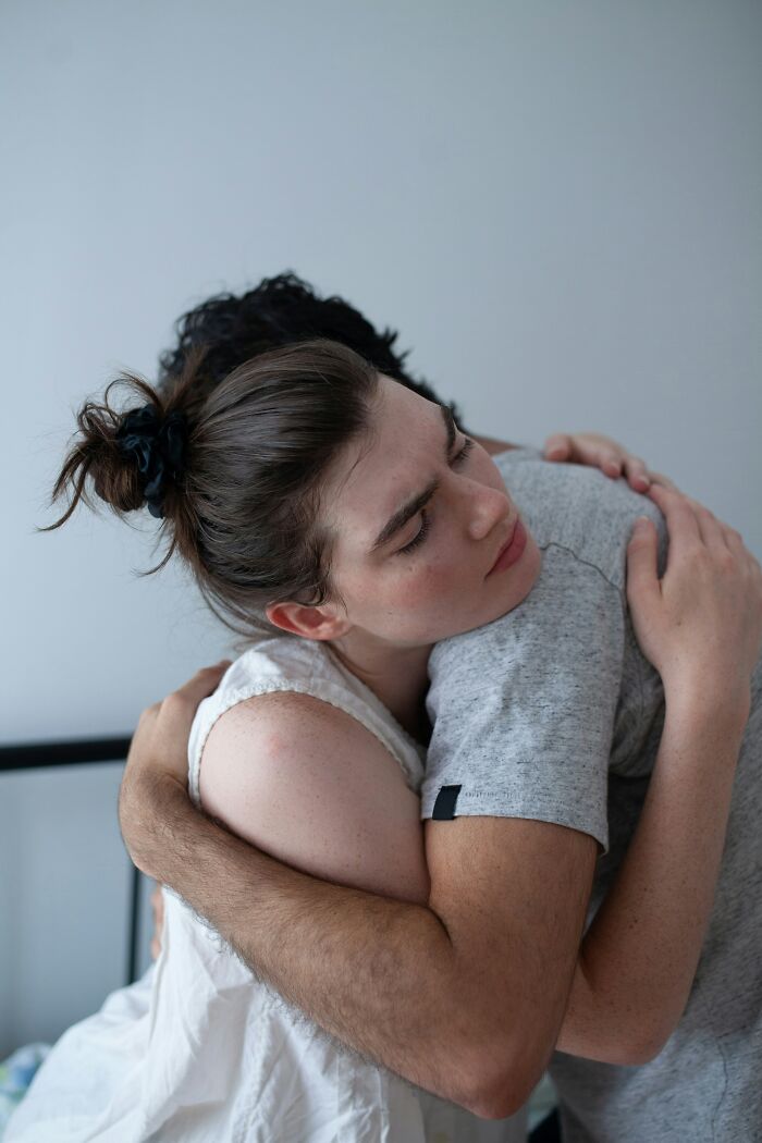 A couple embracing, conveying emotional secrets kept between loved ones.