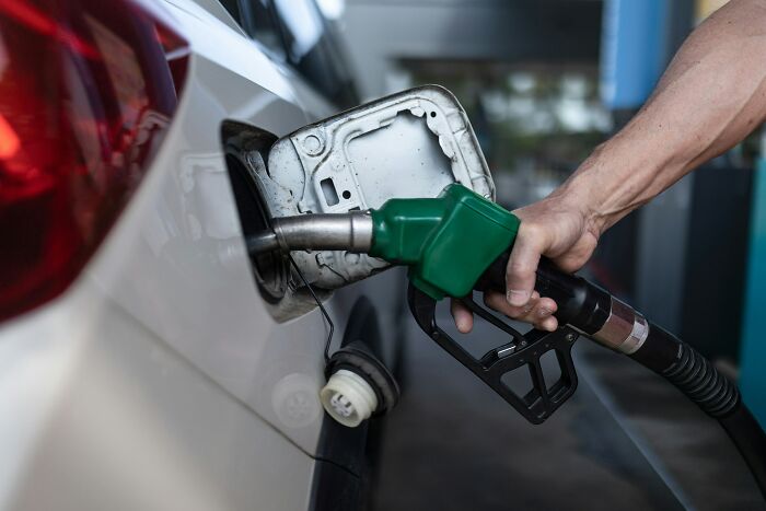 Person fueling a car at a gas station represents one of many insane coincidences experienced by people.