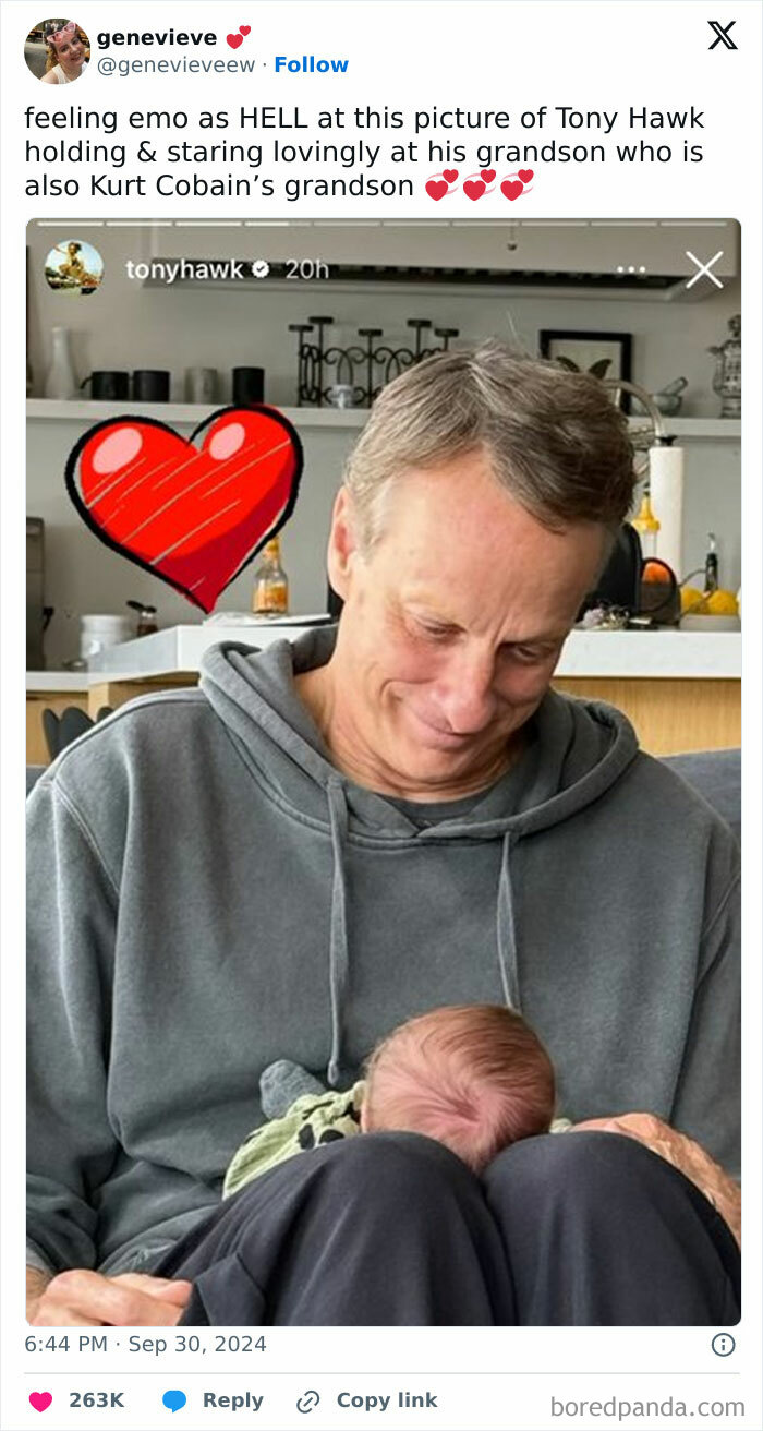 Person smiling at a baby with heart emojis, showcasing a humorous and tender moment.