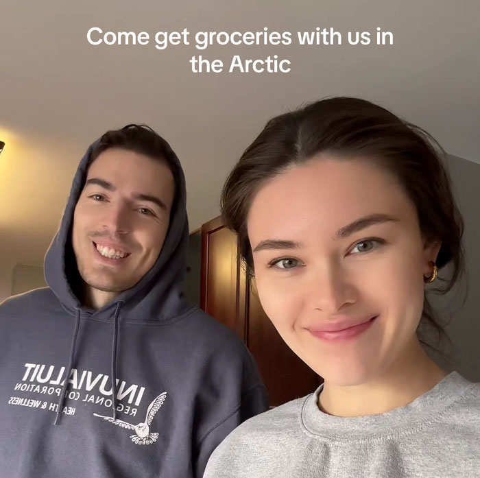 Two people smiling indoors with text "Come get groceries with us in the Arctic," highlighting grocery costs in the Arctic.