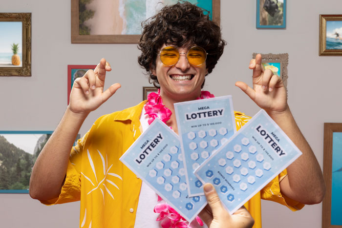 A smiling person in yellow glasses holding lottery tickets, symbolizing financial help and debt relief.