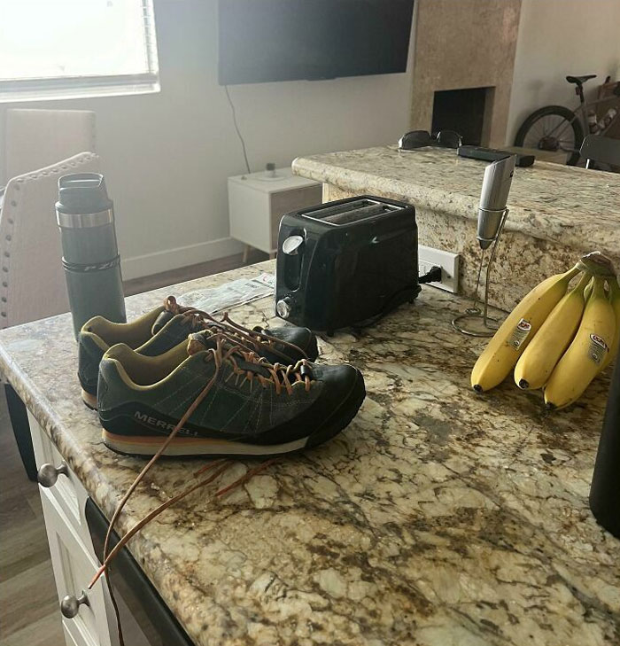 Shoes and bananas on a kitchen counter, illustrating signs of horrible roommates.