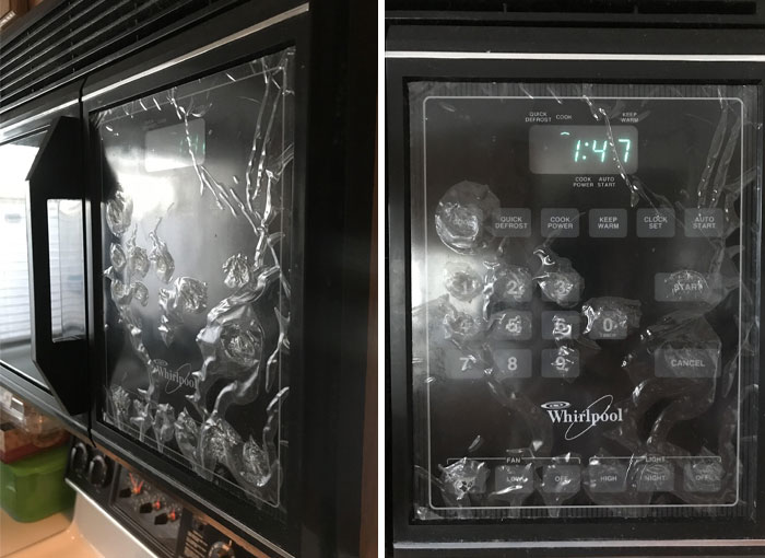 Broken microwave with cracked display and control panel, showcasing typical horrible-roommates scenario.