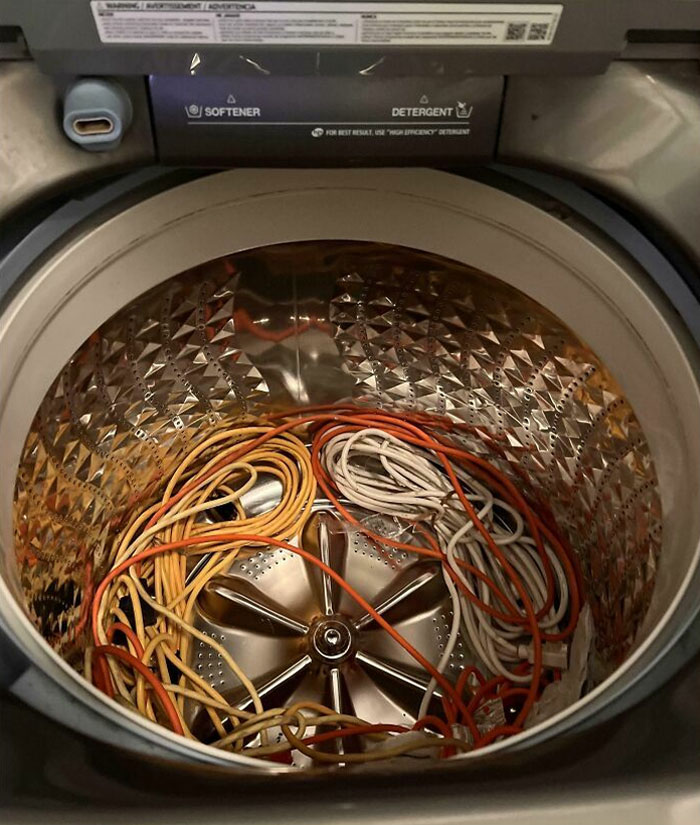 Tangled cables inside a washing machine, depicting horrible roommates and their messy habits.