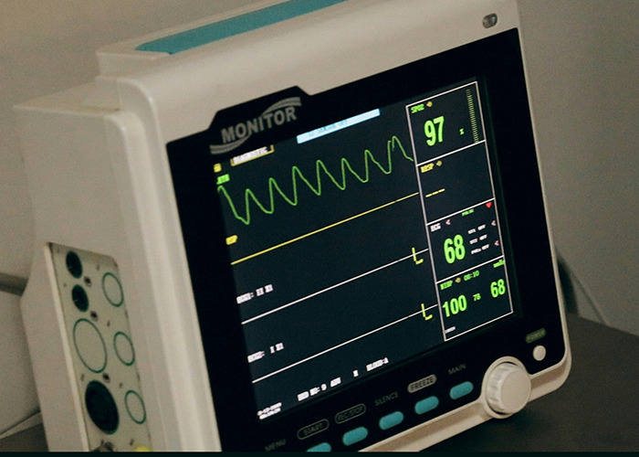 Hospital monitor displaying vital signs, illustrating real-life insurance horror stories with shocking medical scenarios.