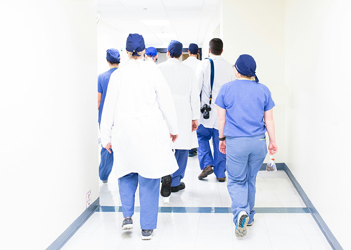 Hospital staff walking down a hallway, highlighting real-life insurance horror stories.