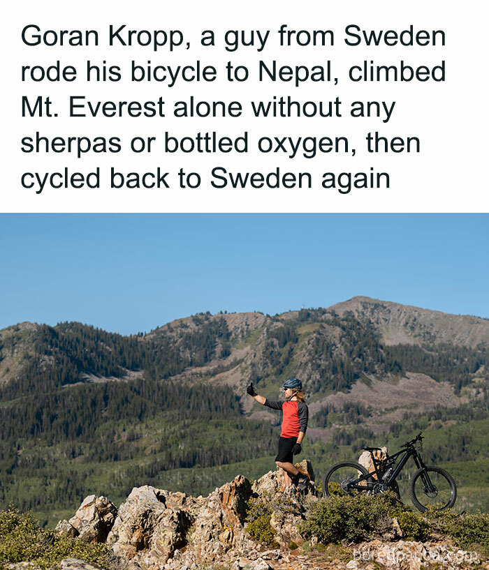 Cyclist on mountain, taking a selfie with bicycle, showcasing interesting facts and curiosities.