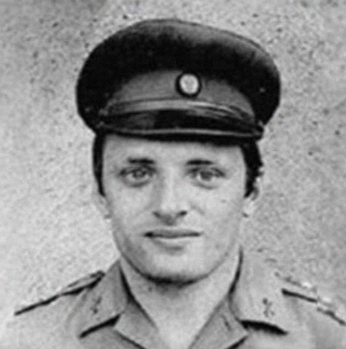 Young soldier in uniform and cap, representing intriguing historical era.