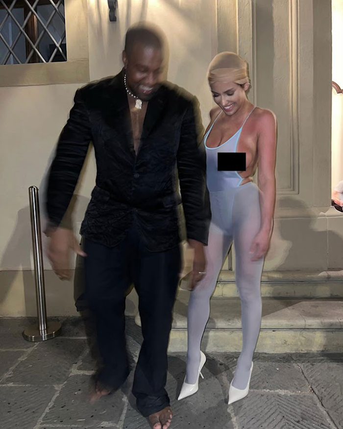 Ye and Bianca Censori in formal attire, with woman in sheer outfit, standing outside a building at night, related to Kim Kardashian and Bianca.