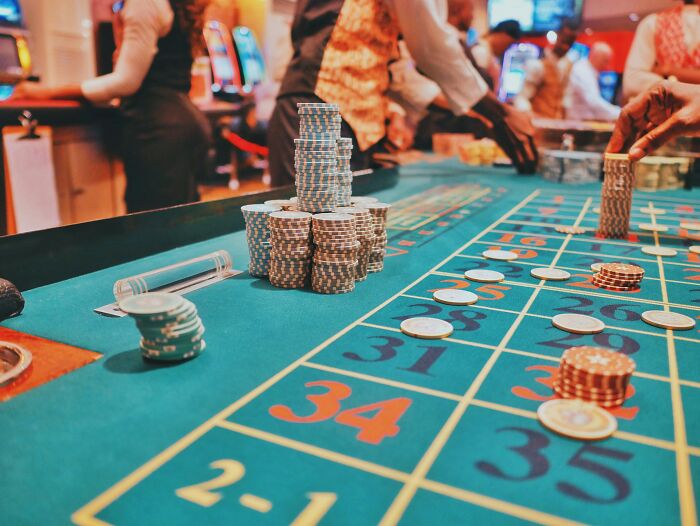 Casino roulette table with stacks of chips, a secret indulgence in gambling.