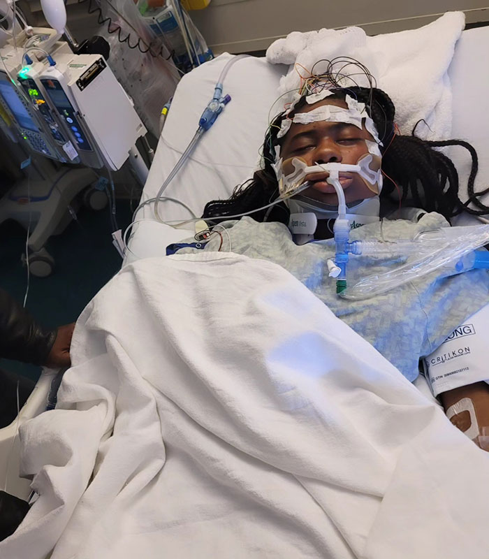 Kelaia Turner in hospital bed with medical equipment, highlighting bullying consequences.