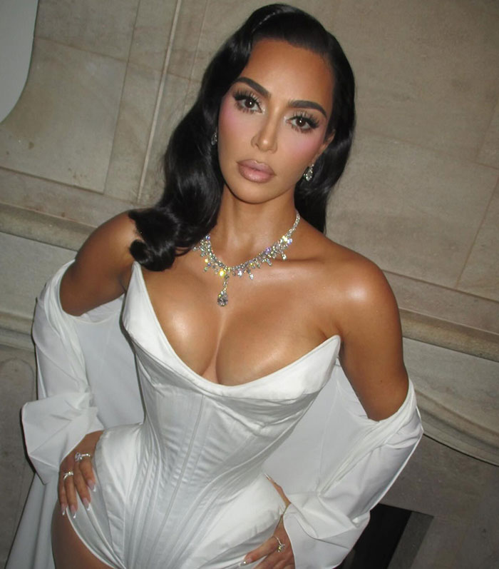 Kim Kardashian in glamorous attire sparking plastic surgery debates among fans.