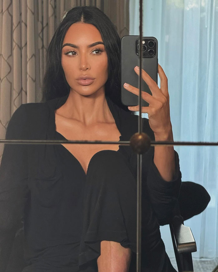 Kim Kardashian mirror selfie, sparking fan debate over potential plastic surgery.