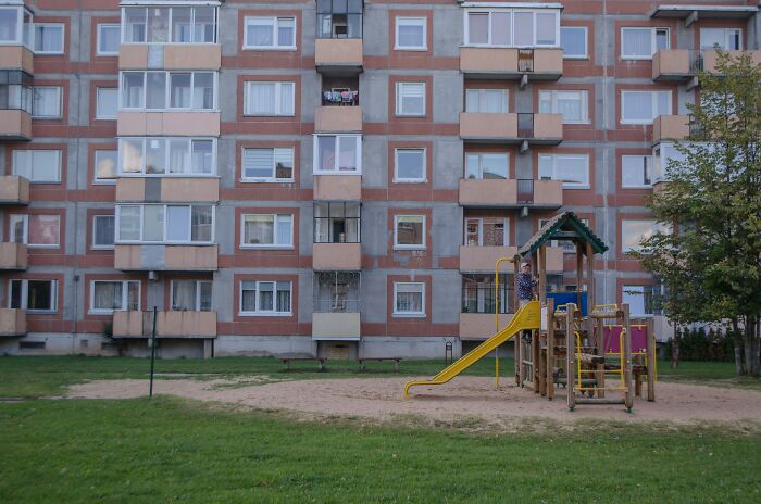 Playground in front of an apartment building, illustrating a coincidence in a familiar neighborhood setting.