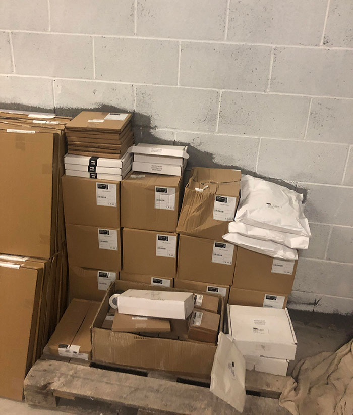 Stacks of disorganized boxes in a storage room, depicting lazy infuriating people.