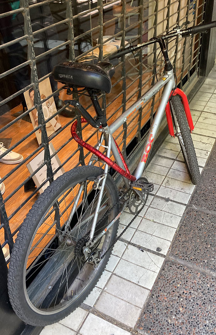 Bicycle frustratingly locked to immovable gate, epitomizing lazy-infuriating-people behavior.