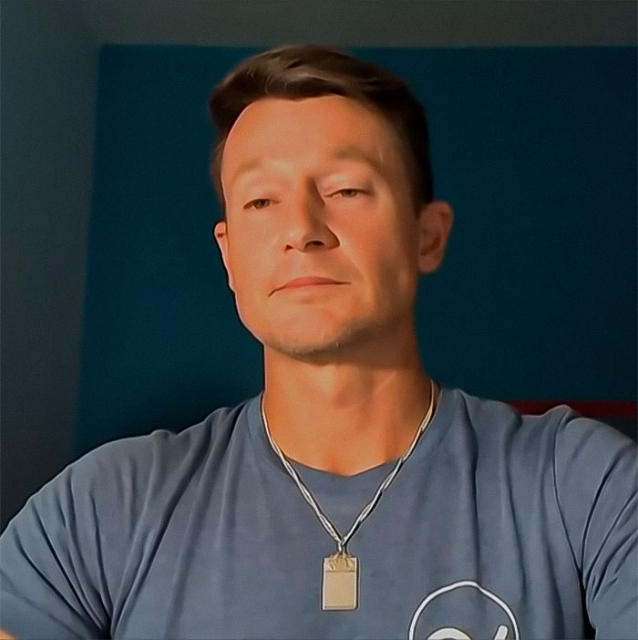 RJ Martin in blue shirt with necklace, reflecting on his manhood in a recent post, facing challenges after an accident.