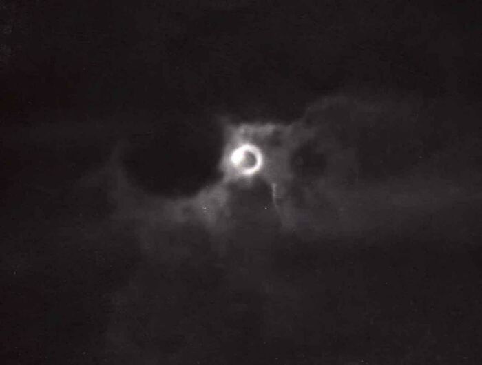 Astonishing coincidence: moon and cloud alignment resembling an eye in the night sky.