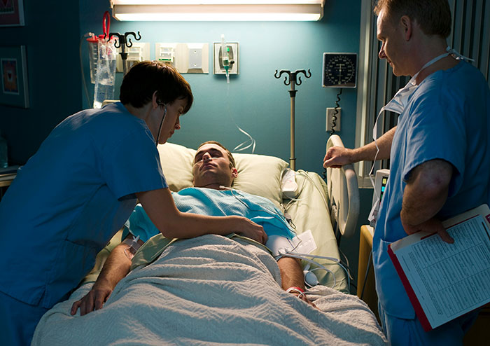 Healthcare professionals tending to a patient in a hospital room, relating to insurance claims and UnitedHealthcare.