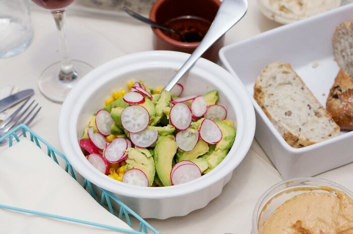 Avocado and radish salad with bread, emphasizing the difference healthy food makes in exercise and well-being.