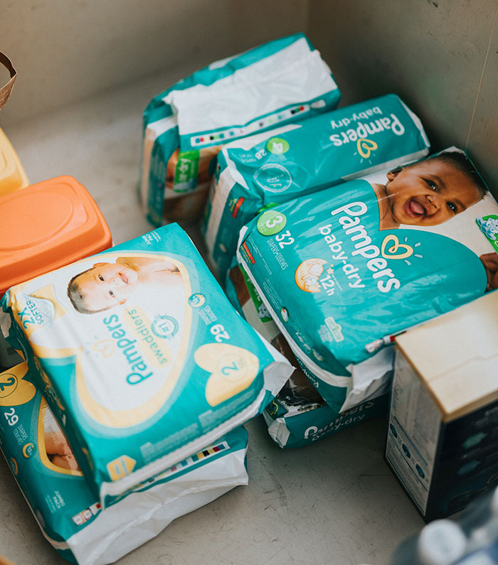 Pampers diapers in various sizes stacked, highlighting misconceptions around baby products and stereotypes.