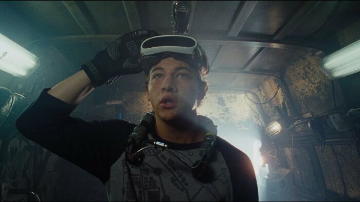 Young man in a dimly lit room wearing VR gear, exemplifying how movies often inaccurately portray women.