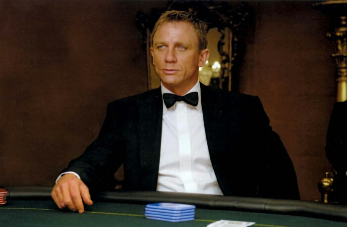 A man in a tuxedo sitting at a poker table, illustrating films' disappointing portrayal of women.