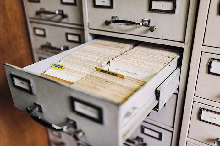 Vintage card catalog drawer open, showcasing an old organization system that confuses people now.