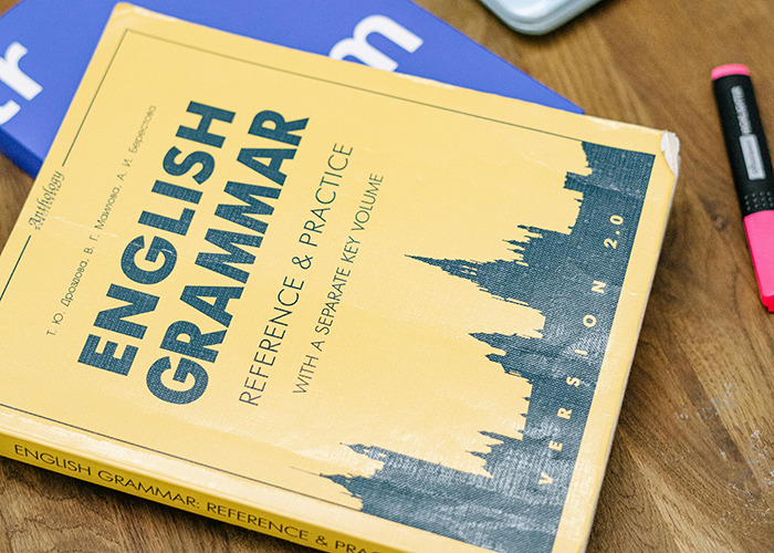 Yellow English grammar book on a desk, representing things that were obvious 15 years ago but confuse people now.