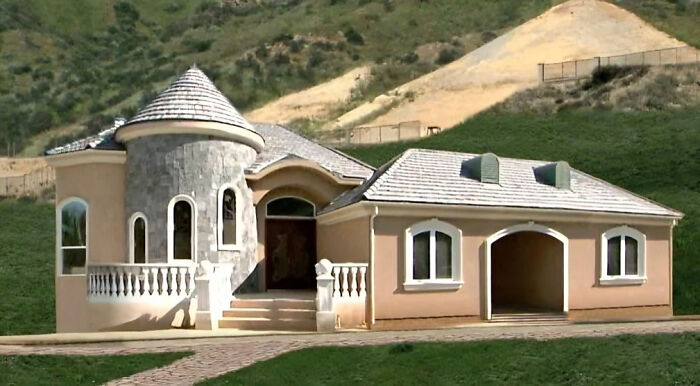 Unusual house design with a turret, highlighting that money can’t buy taste.