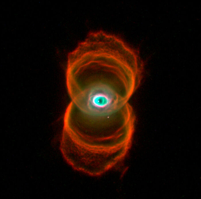 Colorful nebula forming a striking hourglass shape in space.