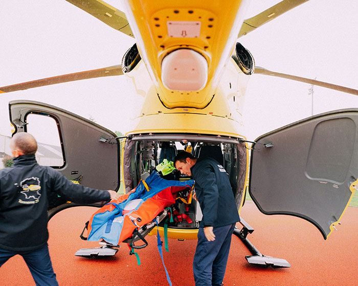 Personnel loading equipment into rescue helicopter, related to insurance claims and UnitedHealthcare CEO discussion.