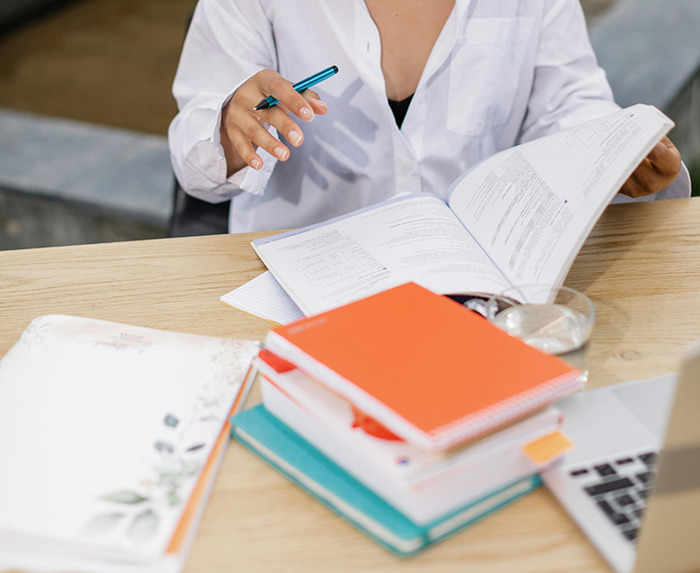 Woman studying at a desk.