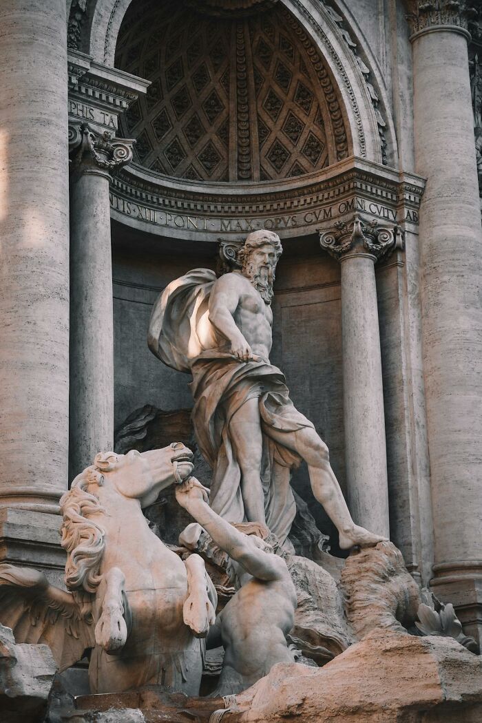 Statue of Neptune with horse sculpture, showcasing classic Roman architecture.