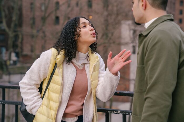 Woman expressing frustration during a discussion, capturing a moment of realizing she's dating an idiot.