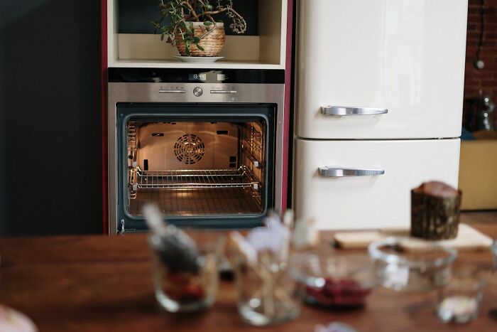 Open oven in cozy kitchen setting with fridge nearby, capturing a moment realized dating idiot.