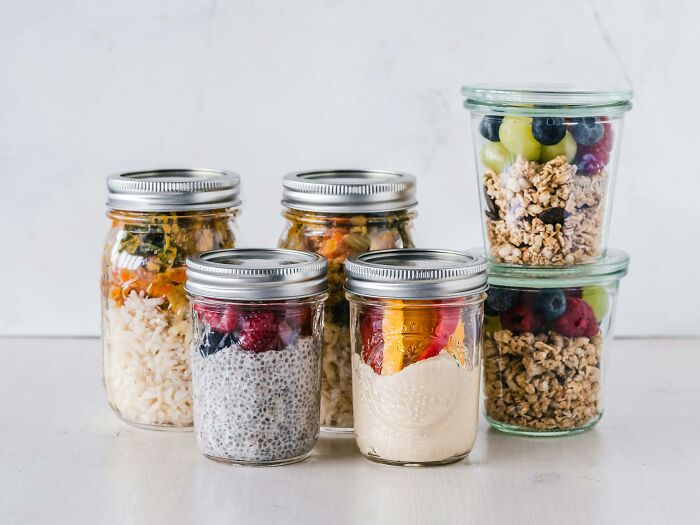 Glass jars filled with grains, chia pudding, and fruit parfaits, highlighting influential lifestyle changes.