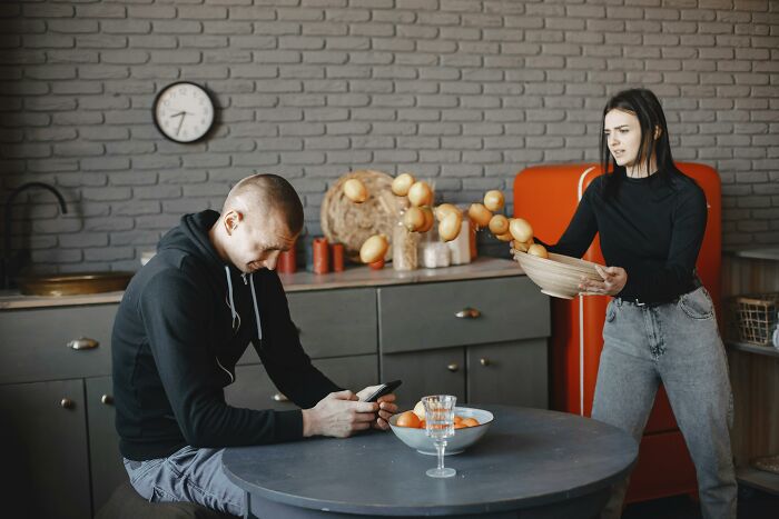 Woman demonstrating culinary skills, juggling potatoes in a kitchen, highlighting the WomenInMaleFields trend.