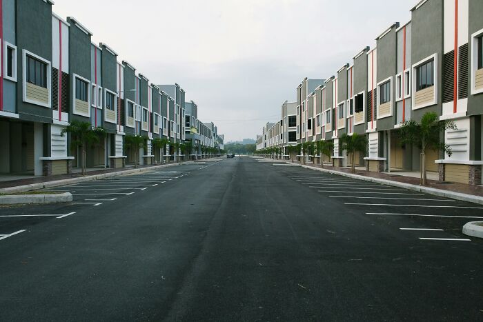 Empty street between rows of townhouses, reflecting peace and quiet.