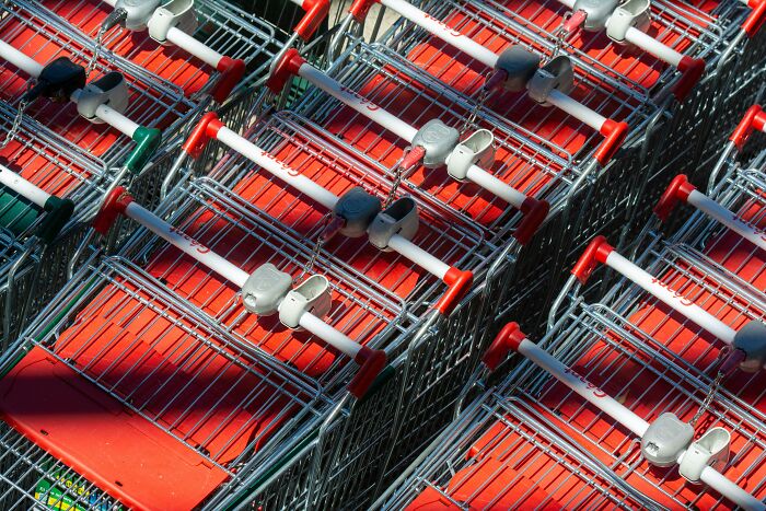 Empty shopping carts in a row outdoors.