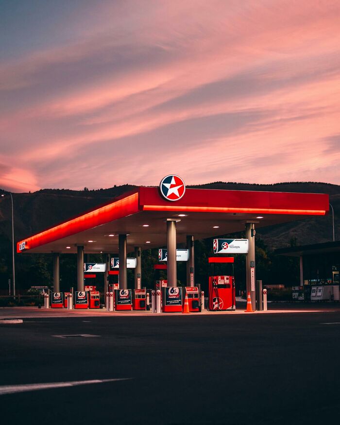 Gas station at sunset, empty with bright lights on, highlighting moment realized dating idiot.