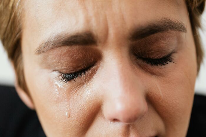 Close-up of a person crying, possibly due to an unexpected escalation of a simple "You Up?" text.