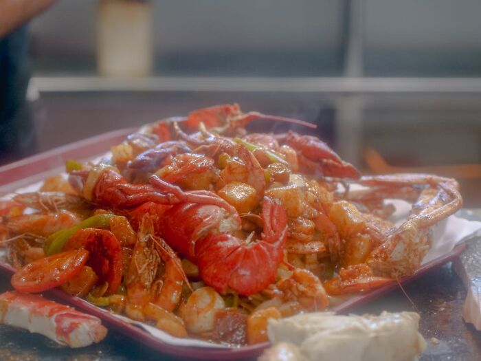 A platter of mixed seafood, including shrimp and crab, served hot and enticing.