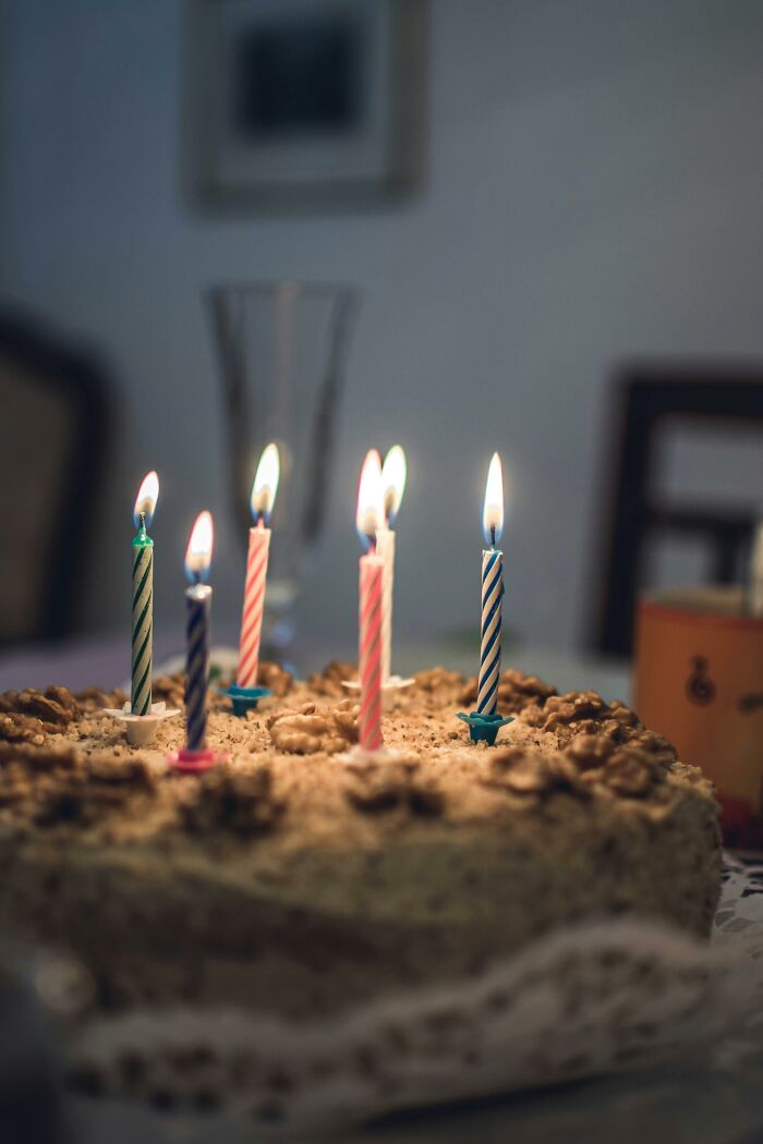 Birthday cake with burning candles, capturing a moment of unexpected excitement and escalation.